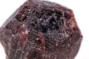 Macro of a mineral garnet stone on a white background photo