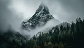 Majestic mountain peak, snow covered, foggy, tranquil scene, wilderness adventure generated by AI photo