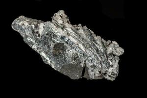 Macro mineral stone Stibnite quartz on a black background photo