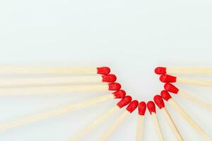 matchstick with a red heart-shaped head on a white background photo