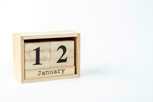 Wooden calendar January 12 on a white background photo