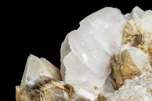 Macro mineral stone Snow quartz with calcite on a black background photo