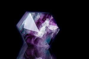 Macro mineral stone Fluorite crystal on a black background photo