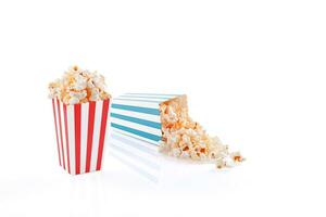 Glass with popcorn on a white background photo