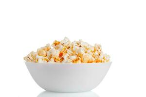 a plate of popcorn macro on a white background photo