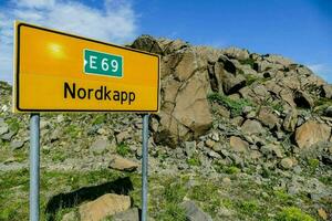 nordkapp road sign in the mountains photo