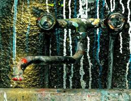 An old sink with paint dripping photo