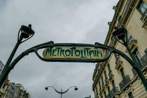 The metropolitan sign hanging between buildings in the city photo