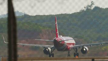 PHUKET, THAILAND FEBRUARY 10, 2023 Airplane takeoff. Airbus A320, HSBBD AirAsia departure at Phuket airport, rear view. Passenger flight leaving. Tourism travel concept. High quality 4k footage video