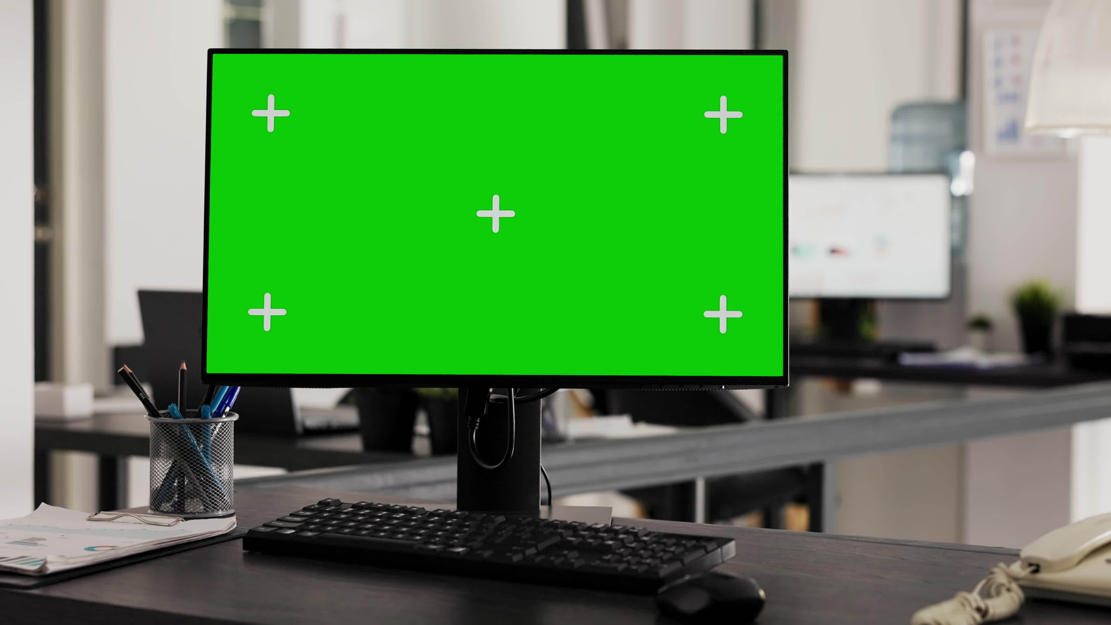 Greenscreen on office workstation placed in creative agency space