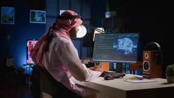 Experienced developer updating neural networks, writing intricate binary code scripts on computer. Muslim worker uses digital device programming to upgrade AI simulation model video