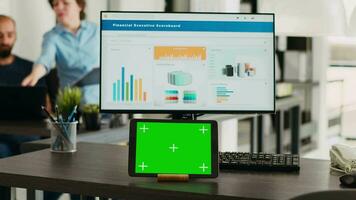 Workstation with greenscreen on tablet device in collaborative workspace for creative firm. In small company workroom advanced gadget displays mockup isolated copyspace screen. video