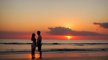 silhouette of a couple on the beach at sunset. photo