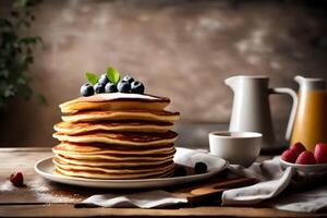 A stack of pancakes with berries and syrup on a wooden table photo