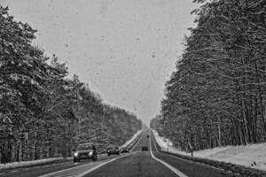 winter road outside the city during snowfall photo