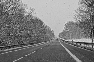 winter road outside the city during snowfall photo