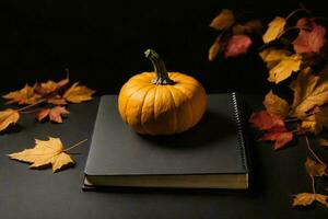 a black Notebook with autumn leaves and a small pumpkin. AI Generative photo