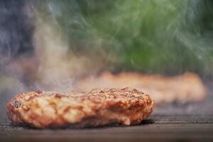 un muy estrecho focal punto en un empanada siendo A la parrilla a un picnic. calle alimento, Cocinando carne. foto