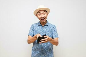 Asian tourism man wear hat happy smile gesture show wallet in his hand isolated photo