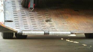 Car tire secured with belt for safety on flatbed tow truck,Securing the load of a car transporter, video