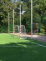 school stadium, green lawn, football goal, tribune, summer day photo