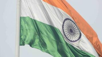 India flag flying high at Connaught Place with pride in blue sky, India flag fluttering, Indian Flag on Independence Day and Republic Day of India, tilt up shot, Waving Indian flag, Har Ghar Tiranga video