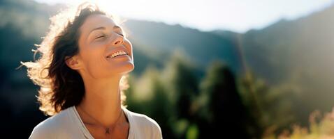 Middle age woman breathing fresh air in the mountains. photo