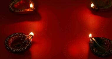 Oil lamp burning with fireworks on red background. Diwali celebration, Deepam festival video