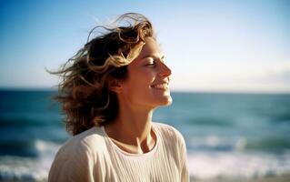 Middle age woman breathing fresh air in the beach. photo