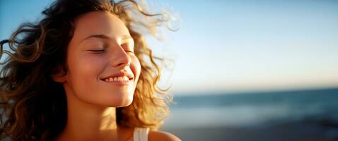 Young woman breathing fresh air in the beach. photo