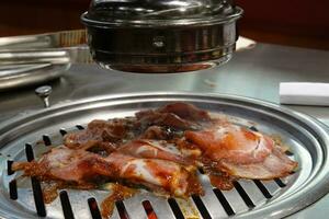 Raw beef and pork slice on grille for barbecue or Korea style photo