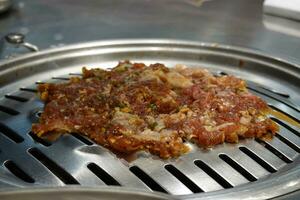Raw beef and pork slice on grille for barbecue or Korea style photo
