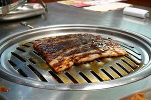 Raw beef and pork slice on grille for barbecue or Korea style photo