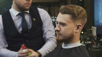 Handsome bearded man getting fire hair treatment at the barbershop video