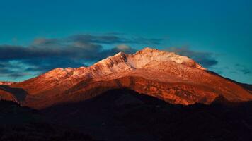 Mountain lit by the last sun of the day photo