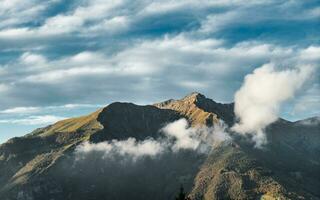 Clouds around a mountain photo