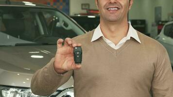 Close-up of the torso and hands of a man who picks up car keys video