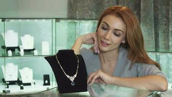 Happy beautiful woman touching diamond necklace smiling cheerfully video