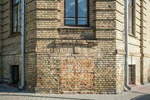 windows with decorative elements on an old wooden or brick building photo