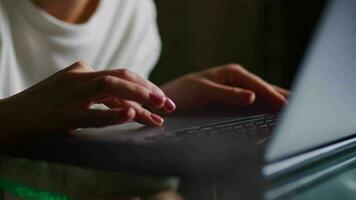 Female hands write text messages on a laptop keyboard close-up. Busy business woman emailing a client using a digital wireless handheld device remotely. Software, online education, apps, concept video