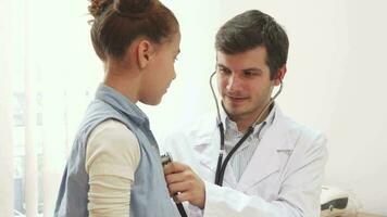 The attentive doctor listens to the lungs of a small patient with a stethoscope video