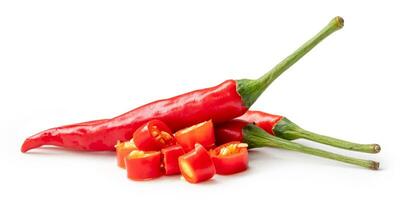 Front view of fresh red chili or peppers with slices or pieces isolated on white background with clipping path. Hot spices photo