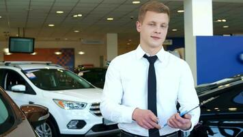 Sales manager shows car key at the dealership video