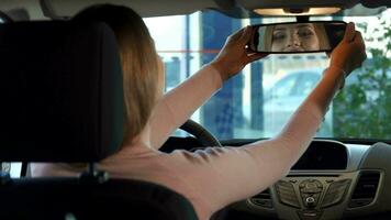 Girl looks into the rear-view mirror video