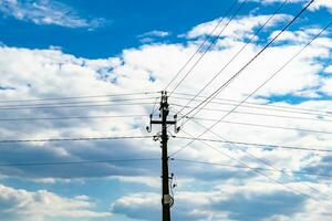 Power electric pole with line wire on colored background close up photo