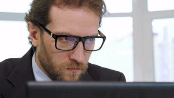 Businessman looking at laptop screen video