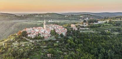 Drone panorama over the historic artists' town of Groznjan in central Istria at sunset photo