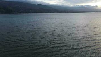 Aerial view over the water of the lake . Aerial view of lake. Flying over water. Flight over calm lake surface video