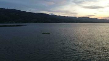 aerial view of a fisherman on his boat in the lake video