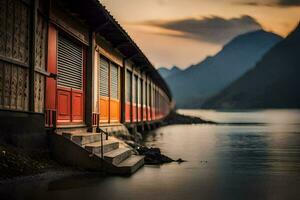 un fila de rojo puertas en el lado de un lago. generado por ai foto